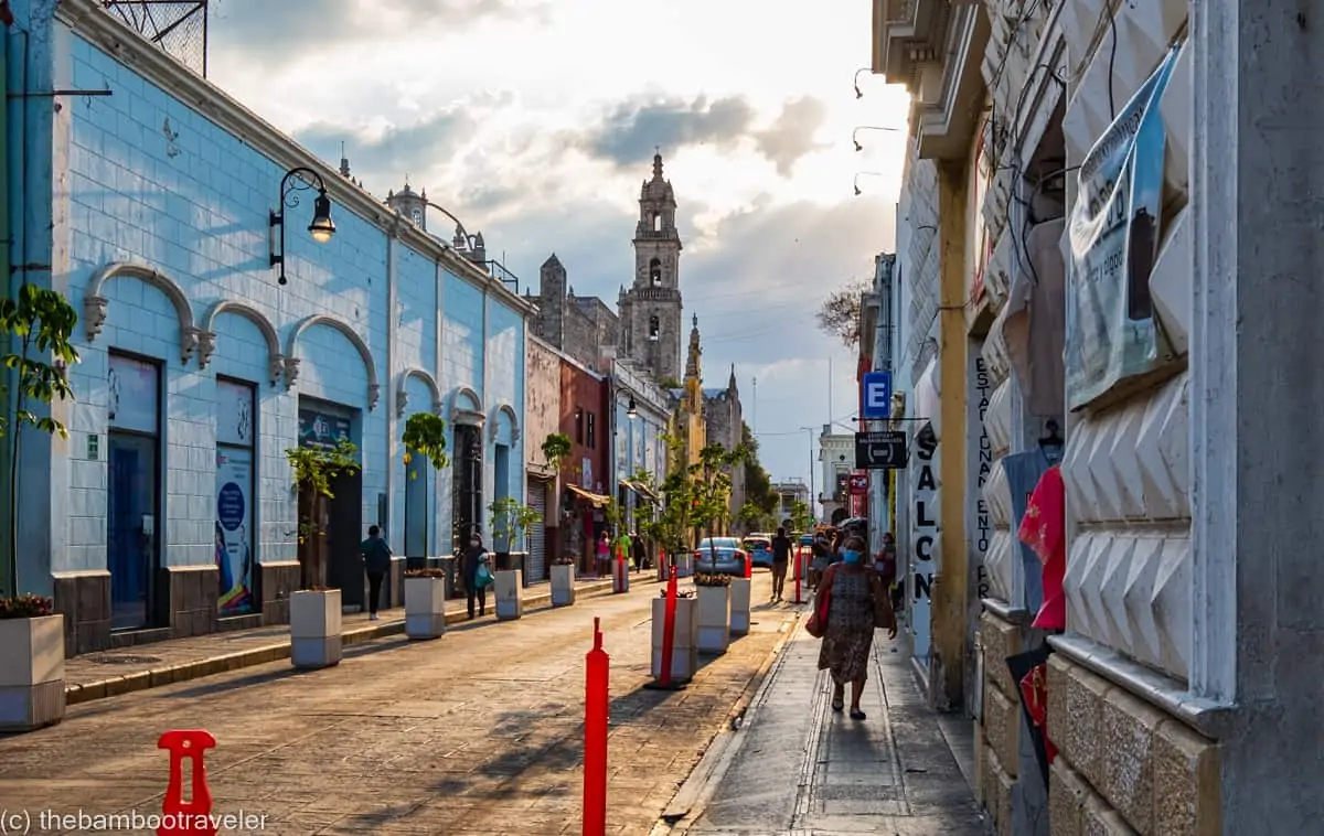 a street lined with colorful colonial buildings at dusk in Merida Mexico