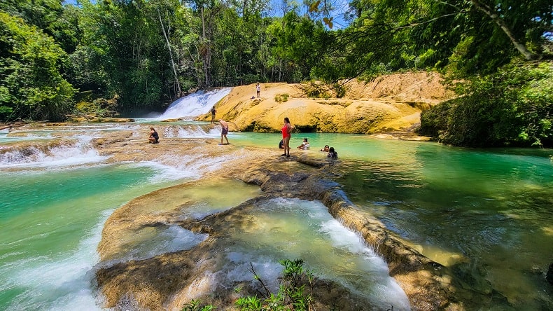 people playing and swimming in the Roberto Barrios Waterfalls