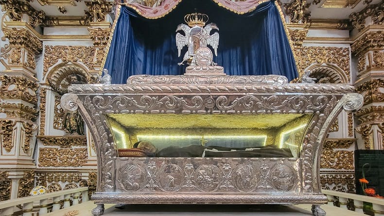a dead body of a monk in a coffin