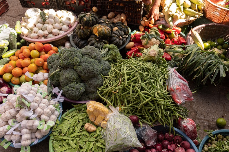 piles of different vegetables at a market in Antigua, Guatemala