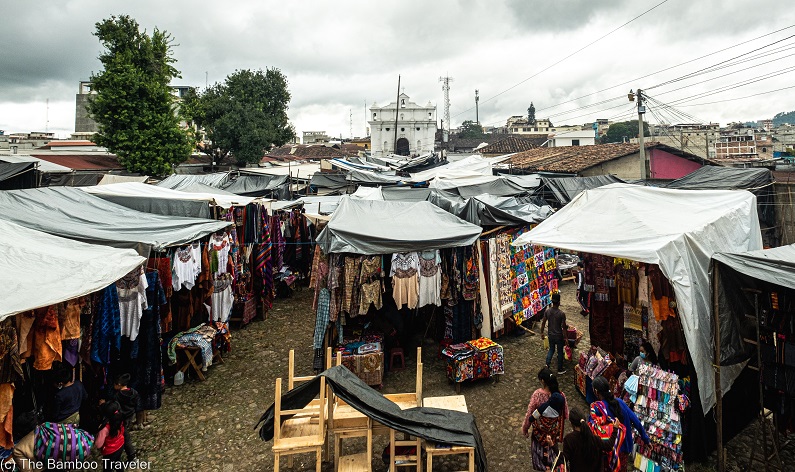 an outdoor market with stalls covered in white tarp at Chichicastenango, Guatemala