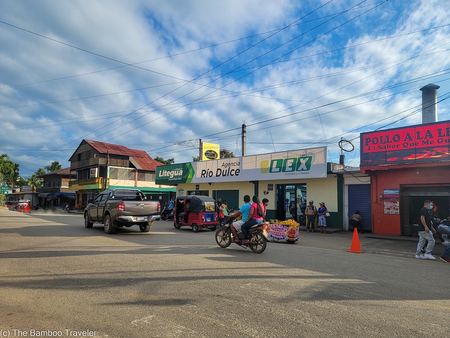 vehicles passing by the Litegua Bus Station in Rio Dulce