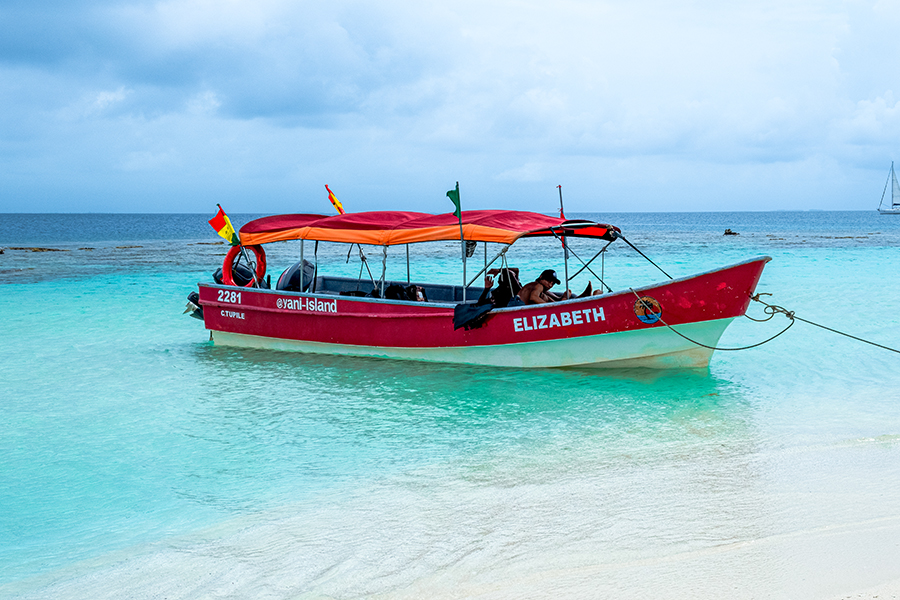 a speed boat next to a sandbar in the San Blas Islands