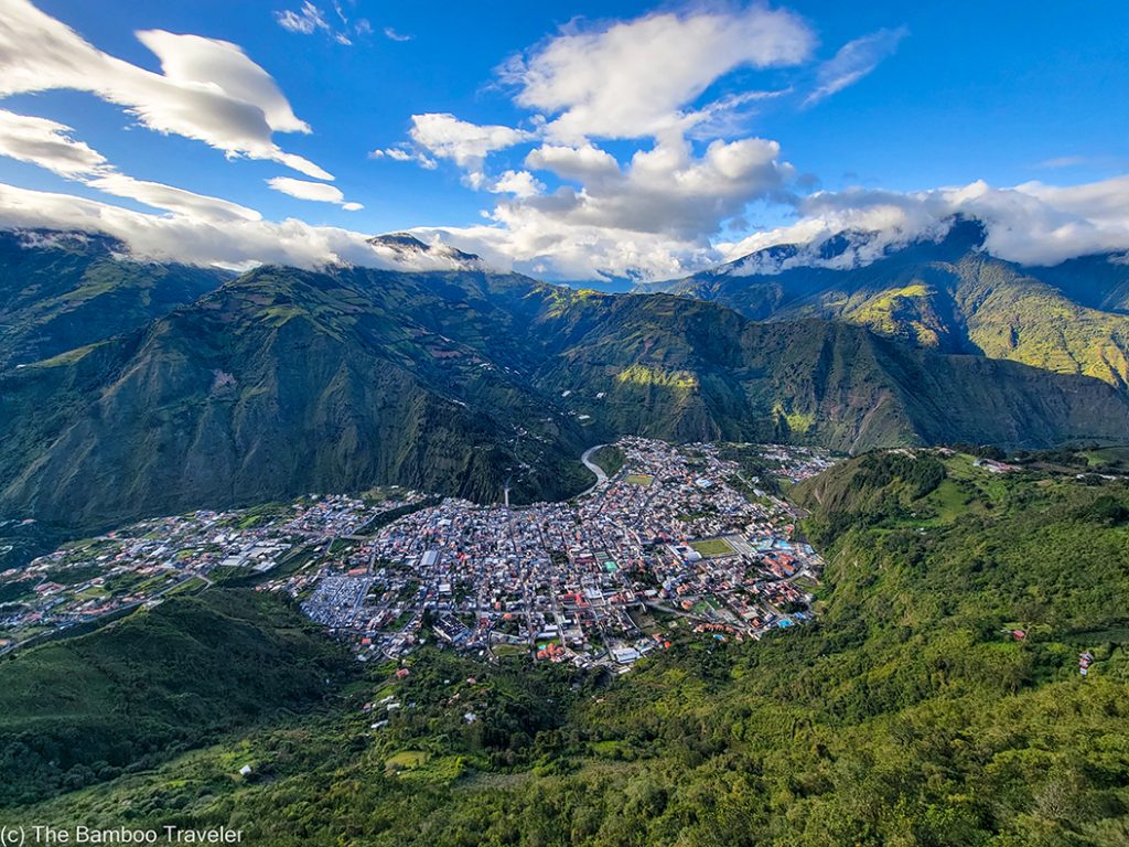 an aerial view of a city in a valley surrounded by mountains