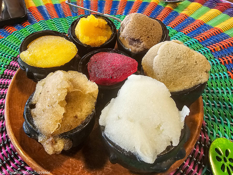 a plate with six small bowls of nieve icecream, a popular Oaxacan street food