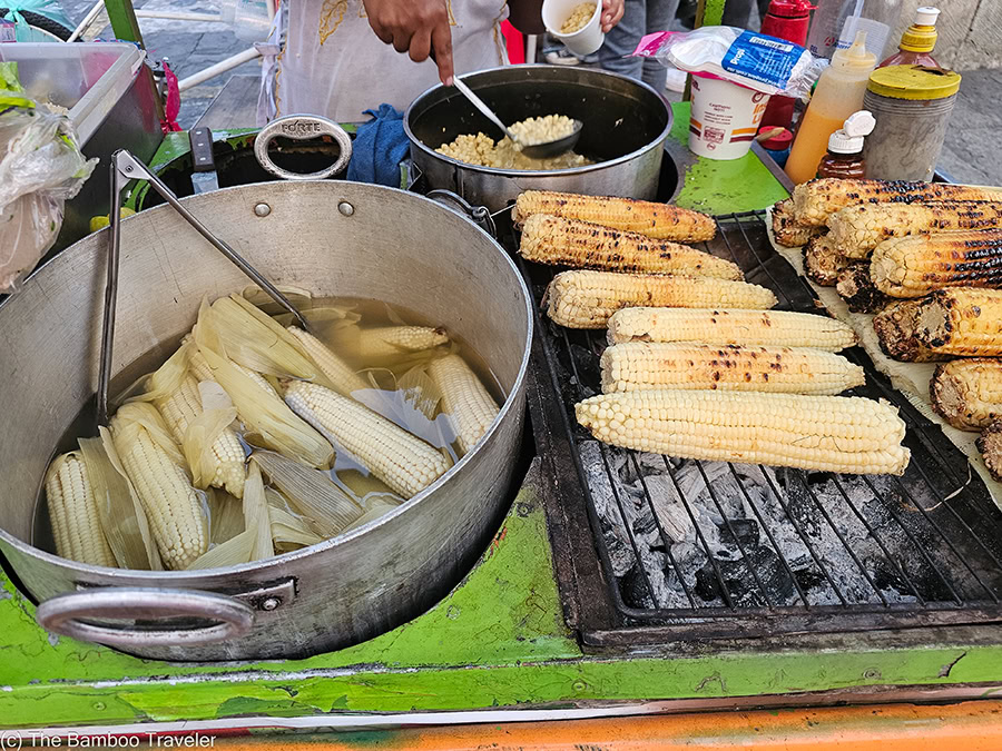 corn cobs cooking on a grill