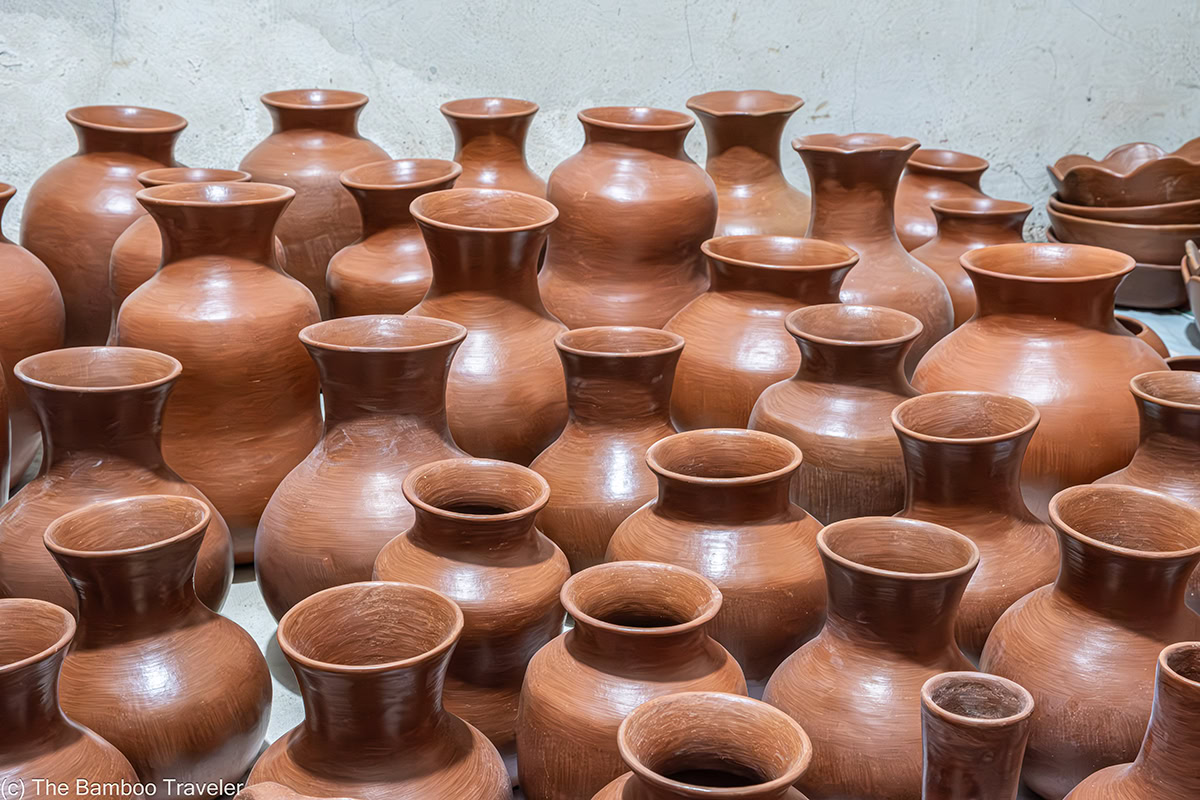 a room full of red clay pottery