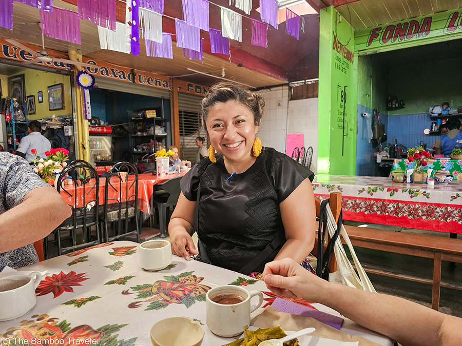 Betsaida from Me Encanta Oaxaca Food Tour sitting at a table and smiling
