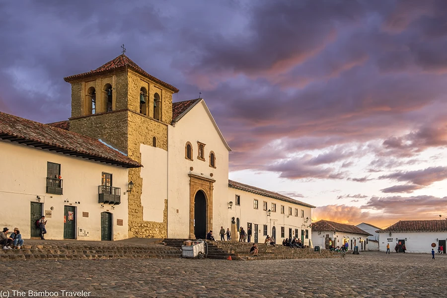 a church in a squar at sunset