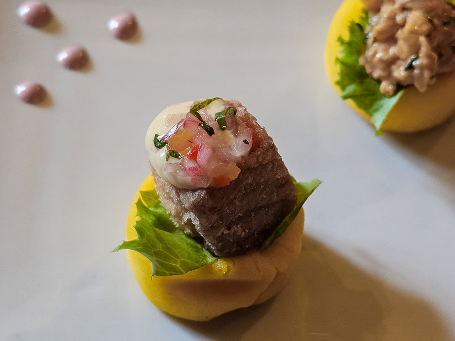 A causa - mashed potatoes topped iwth a piece of tuna and some red onions